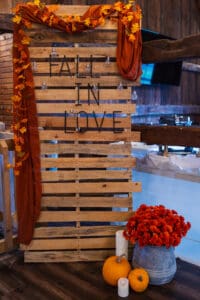 Autumn-themed decor with pumpkins and flowers.