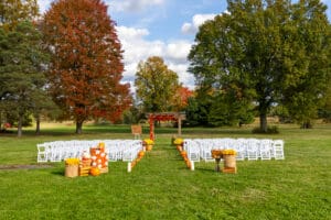 Outdoor wedding setup with autumn decorations.