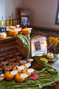 Mini pumpkins displayed with decorative fall accents.