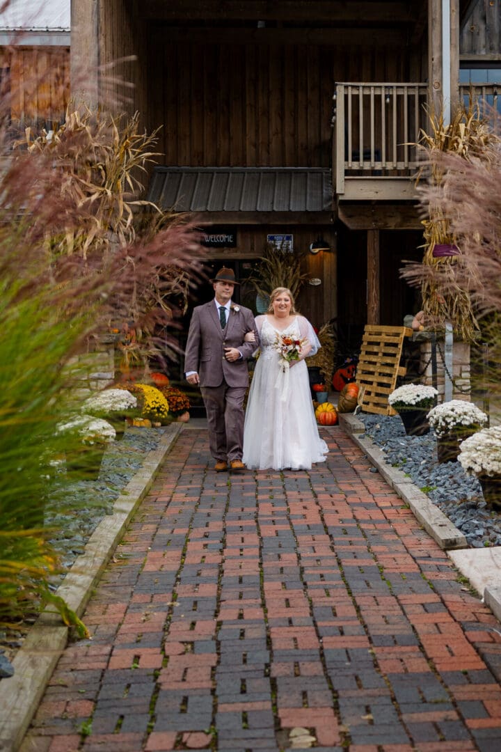Bride and groom walking down brick path