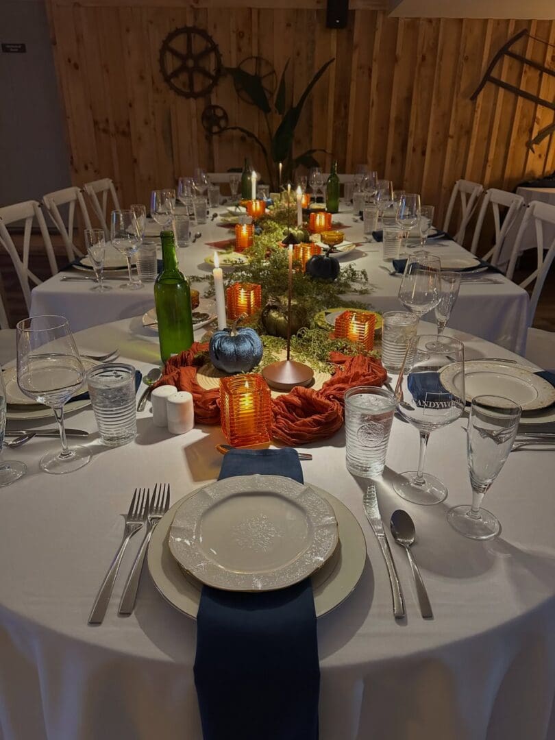 Candlelit rustic banquet table with place settings